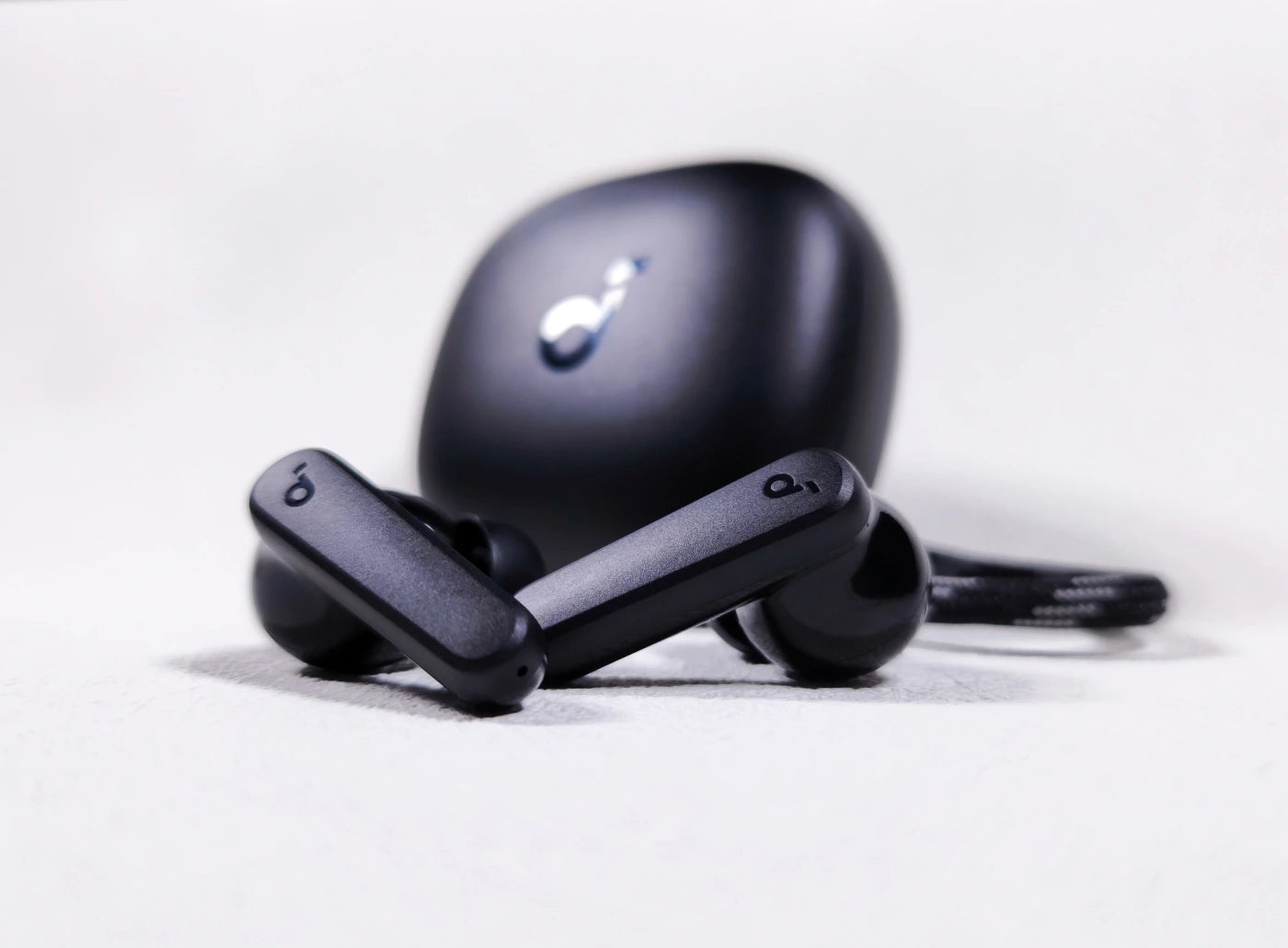 Black Soundcore P20i earbuds displayed upright with case, highlighting stem and earbud design.